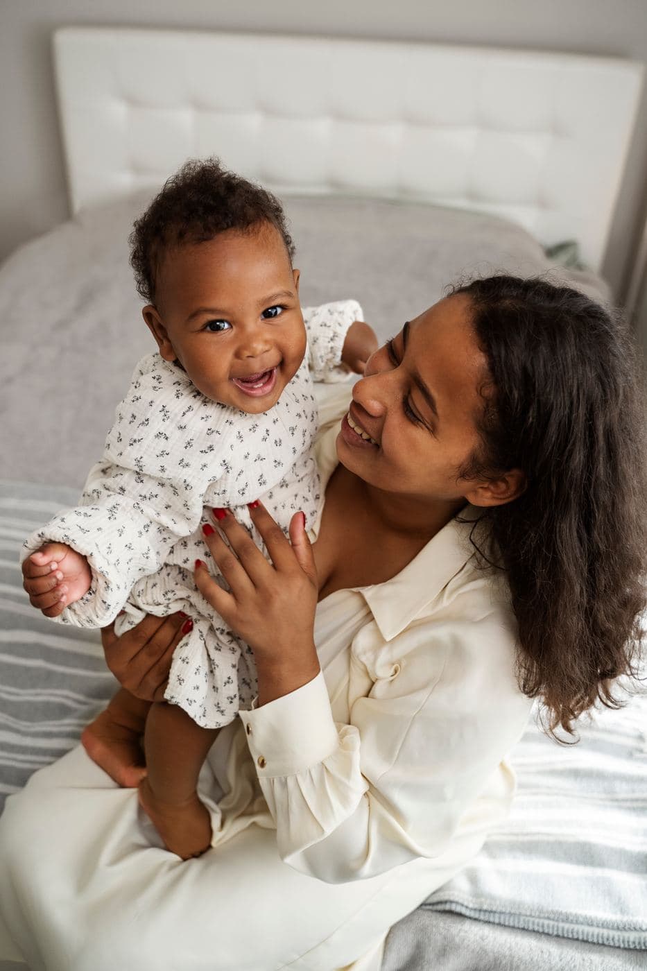 A mother laughing with her baby